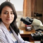 Dr. Manisha Shrestha with microscope